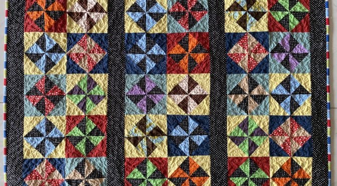 Glowing Pinwheels Quilt and pattern (not quite Amish) susies-scraps.com